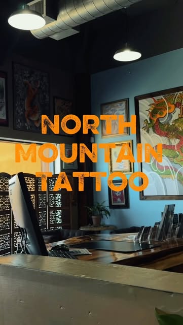 Interior view of North Mountain Tattoo with artwork displayed on the walls